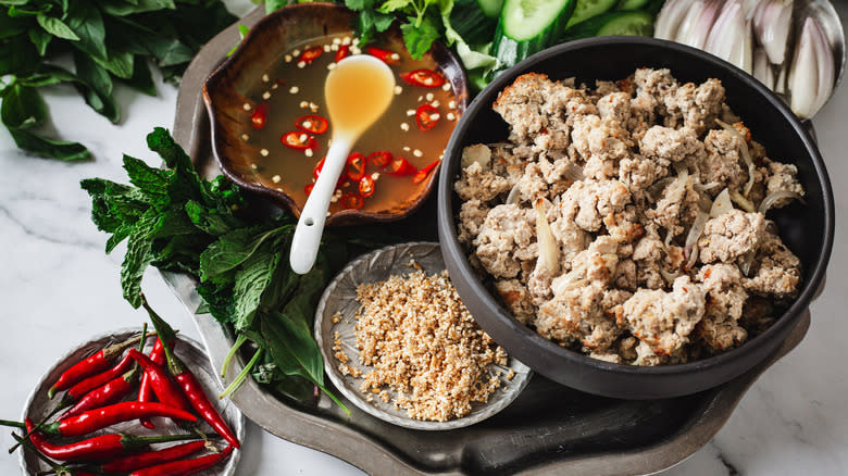 Turkey wrap ingredients on a metal tray with red chilies