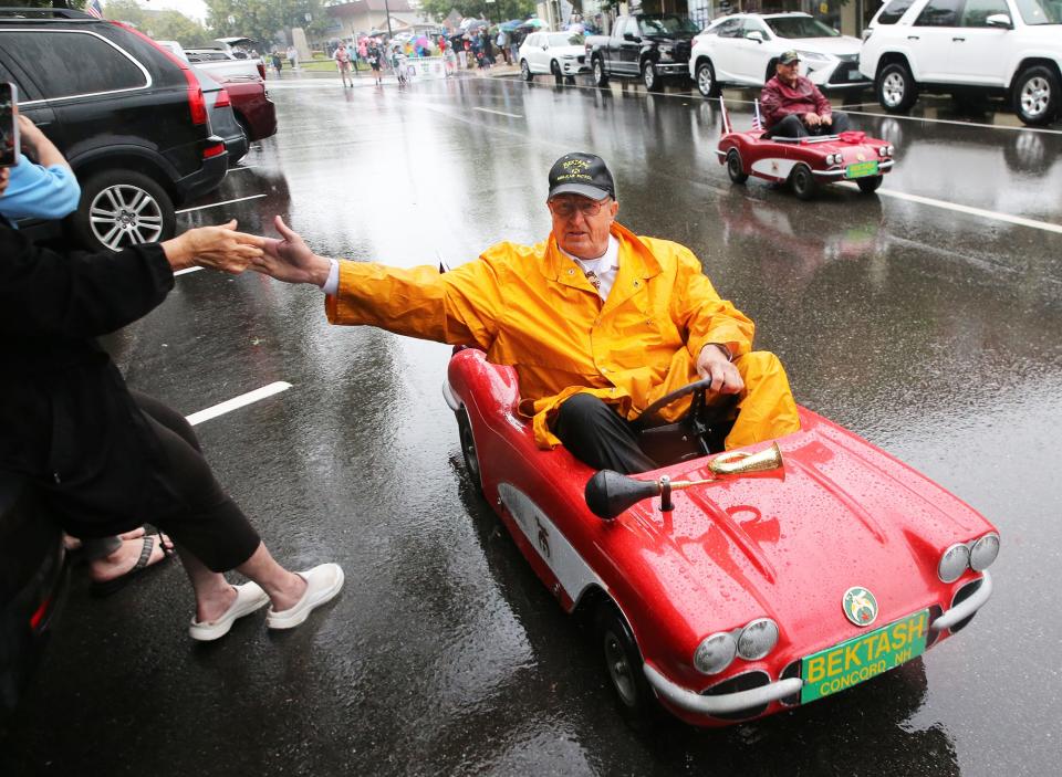 A Bektash Shriner gives high fives to the spectators while making his way down Centeral Avenue during the 2023 Dover 400th Anniversary Parade on Sunday, July 2. 