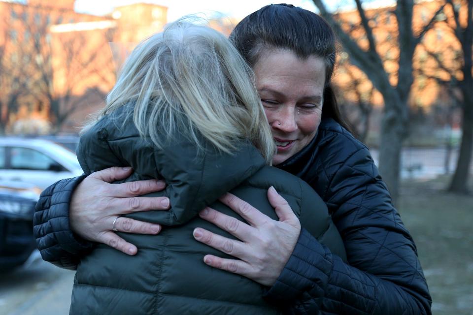 Lori Brown, left, receives a hug Thursday, Jan. 20, 2022 from Michelle Cook, who credits Brown with saving the life of her mother Gisele Tibbets in Dover.