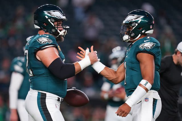 <p>Mitchell Leff/Getty</p> Jason Kelce #62 and Jalen Hurts #1 of the Philadelphia Eagles embrace prior to the game against the Minnesota Vikings at Lincoln Financial Field on September 14, 2023 in Philadelphia, Pennsylvania