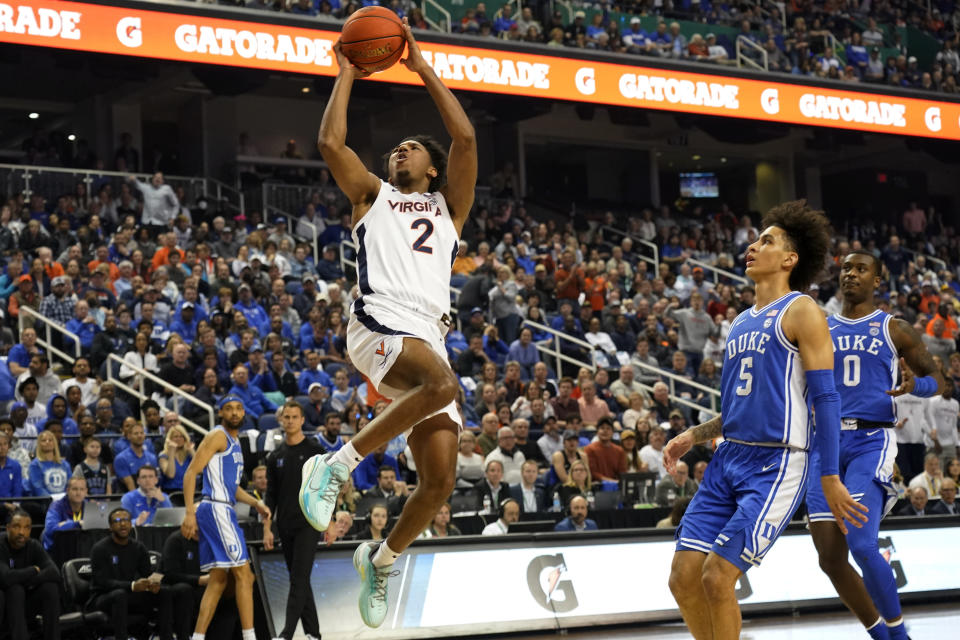 Virginia guard Reece Beekman (2) drives past Duke guard Tyrese Proctor (5) during the first half of an NCAA college basketball game for the championship of the Atlantic Coast Conference tournament in Greensboro, N.C., Saturday, March 11, 2023. (AP Photo/Chuck Burton)