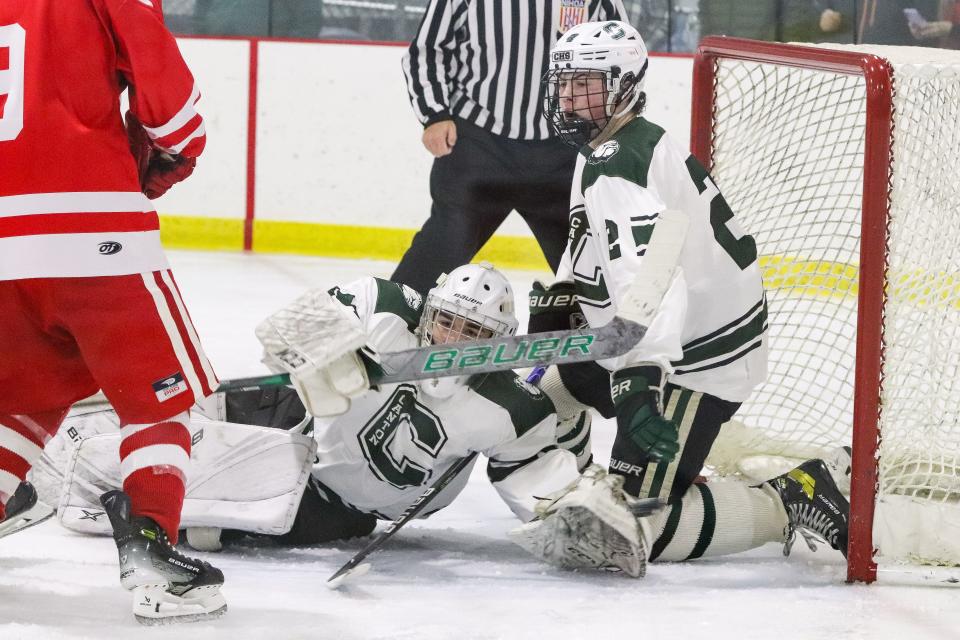 Canton's Connor Geoghan makes a diving save during a game against Barnstable at Canton Metropolis Rink on Saturday, Dec. 16, 2023.