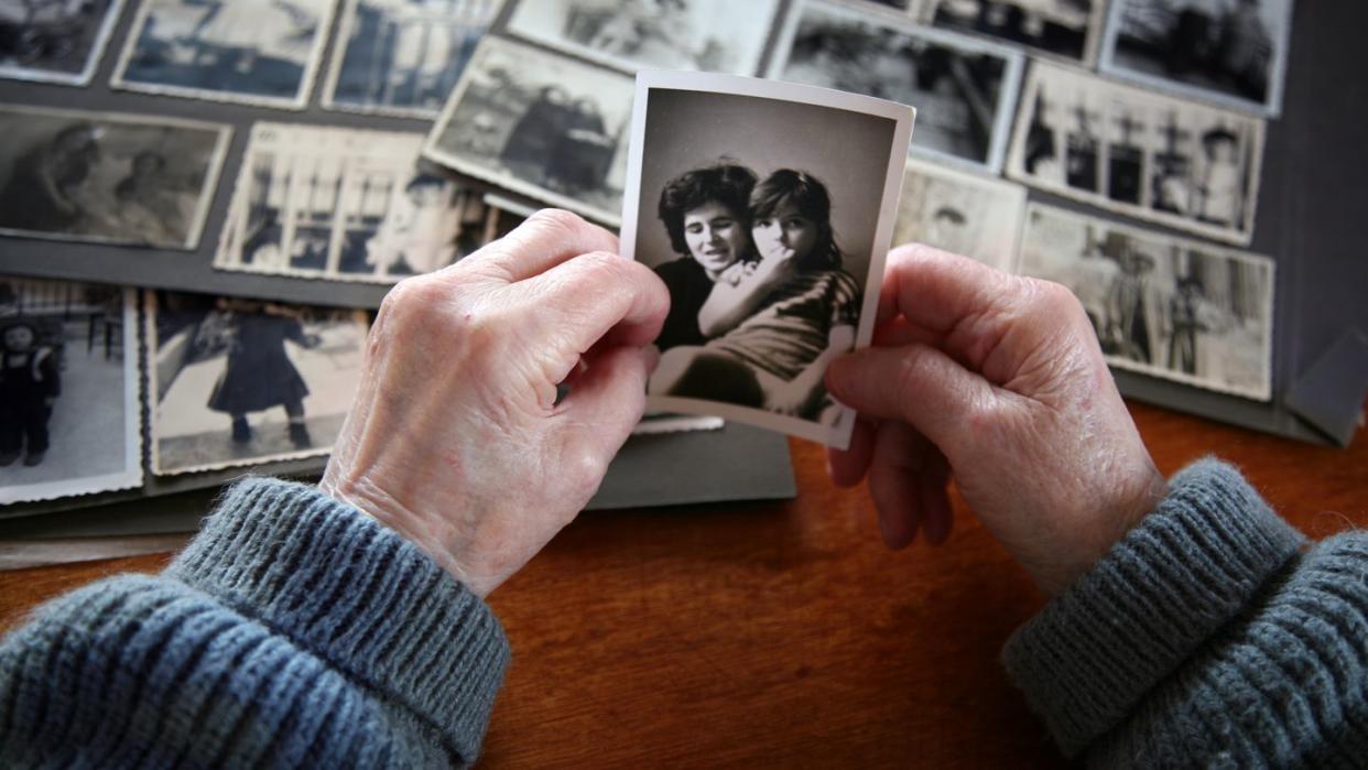 loss of mother quotes elderly hands looking at old photos of self and family