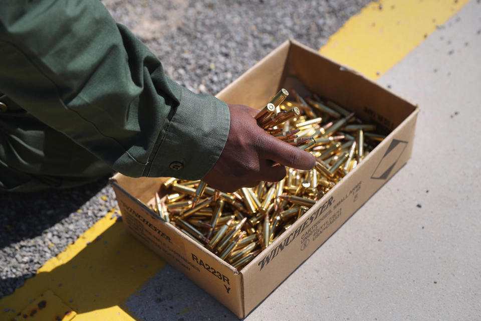 <p>A U.S. Border Patrol trainee grabs a handful of bullets before loading his magazine at a weapons training class at the U.S. Border Patrol Academy on August 3, 2017 in Artesia, N.M. (Photo: John Moore/Getty Images) </p>