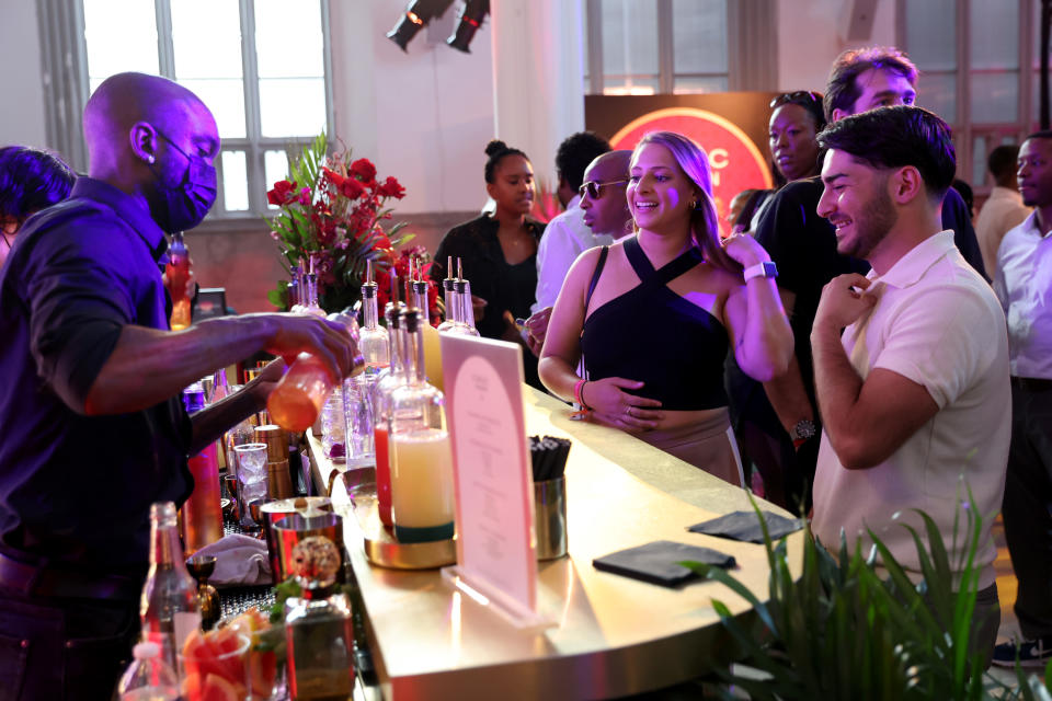 Guests Celebrate The Arrival of CÎROC Passion at Chateau CÎROC drinking curated cocktails at the bar