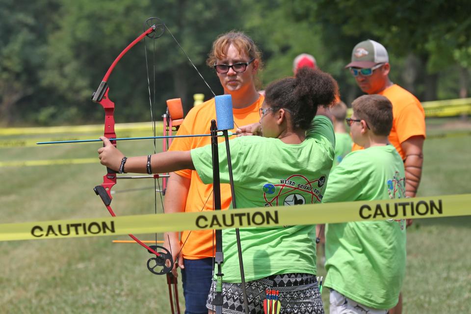 Niylah Stamm, 10 of Fremont, gets instruction on the archery range from her instructor Amy Lay.