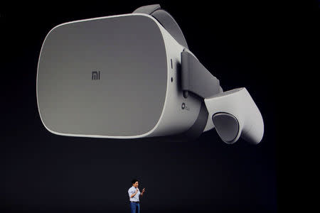 FILE PHOTO: Xiaomi founder Lei Jun introduces a new VR headset during a product launch in Shenzhen, China May 31, 2018. REUTERS/Bobby Yip/File Photo
