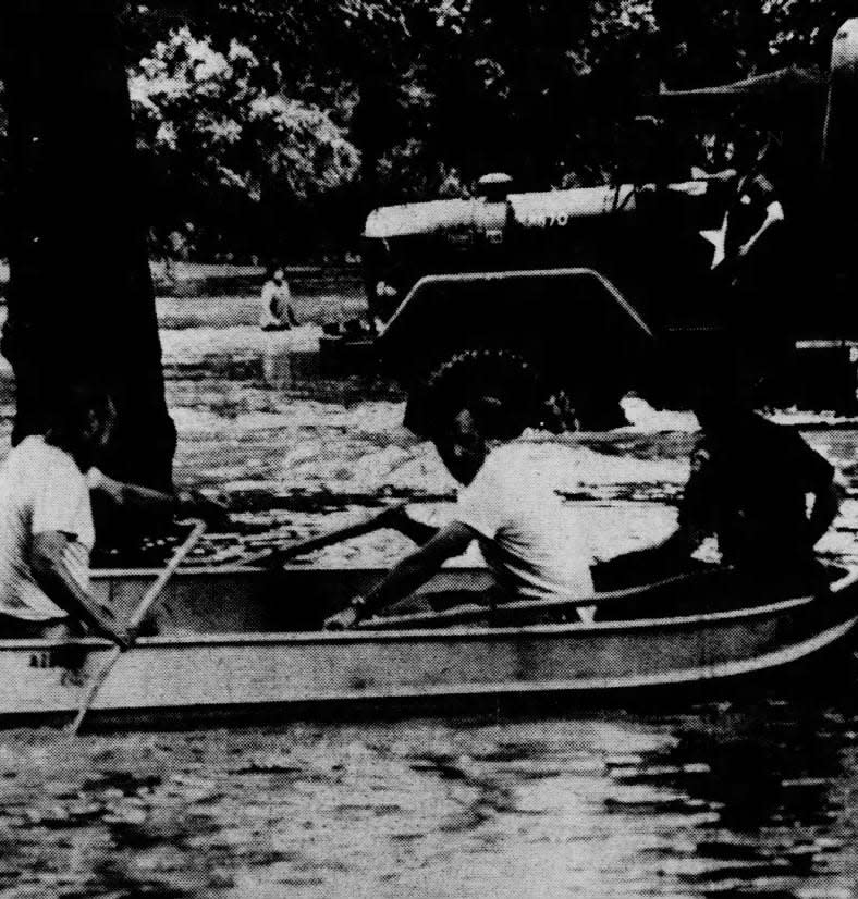 In this Friday, Aug. 3, 1973, file photo, reservists floated past Cedarbrook Road and Watchung Avenue in Plainfield, on their rescue operations.