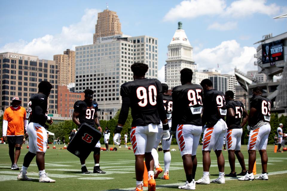 Cincinnati Bengals defensive tackle Tariqious Tisdale (97) holds a pad while preparing to run a drill during preseason training camp at Paul Brown Stadium Aug. 8, 2022.