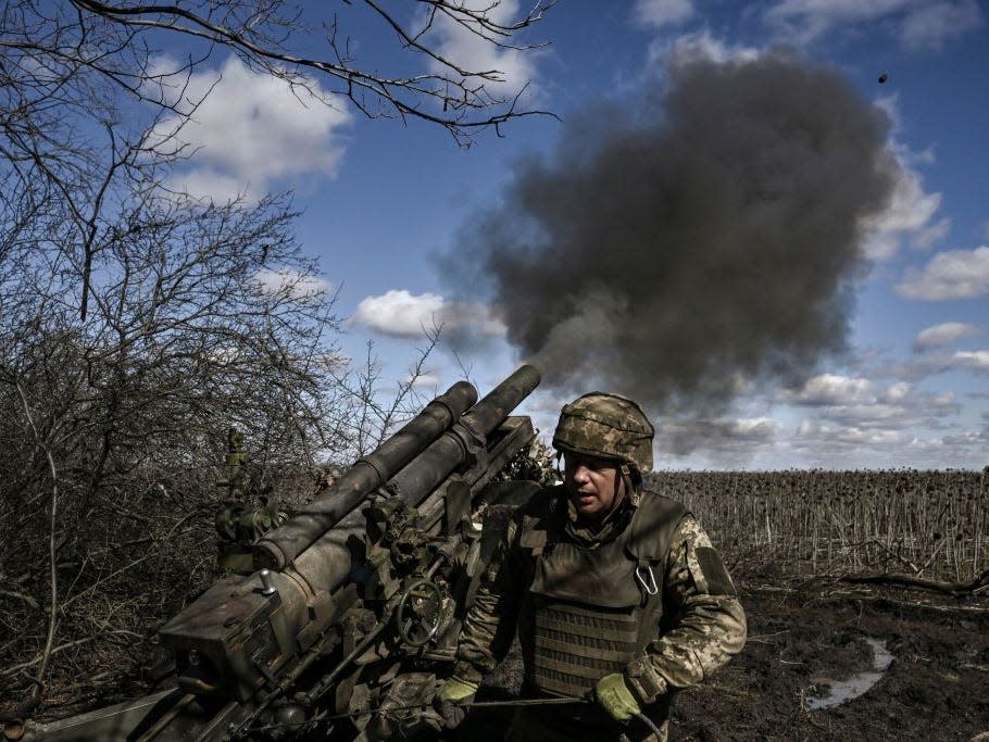 Ukrainian servicemen fire at Russian positions with a 105mm howitzer in the region of Donbas, on March 13, 2023.