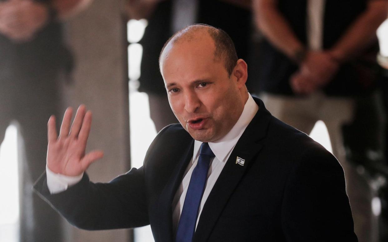 The new Israeli Prime Minister Naftali Bennett waves during a joint photo with the new government ministers at the President's residence in Jerusalem, - Shutterstock/Shutterstock