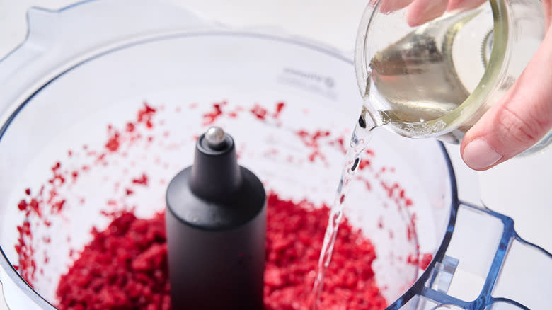 pouring liquid into food processor