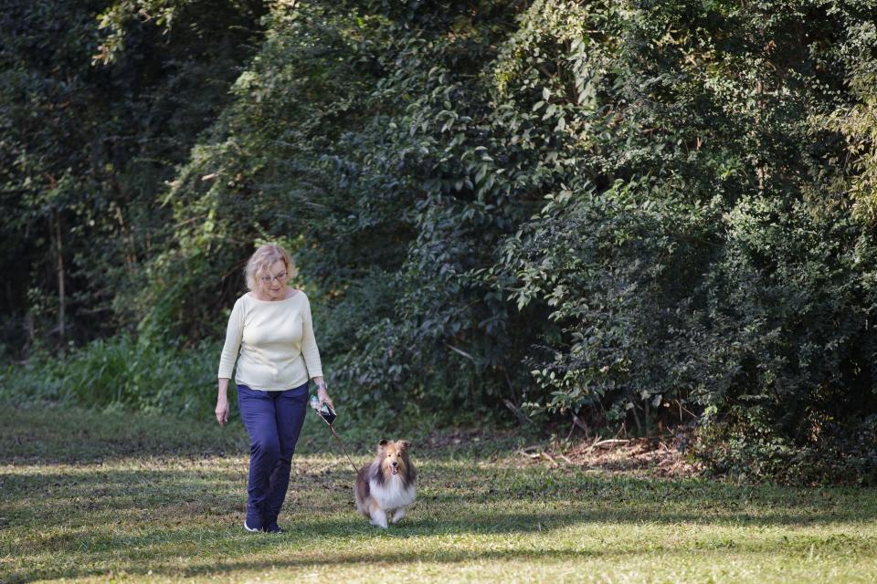 Ali Darrow walks her dog, Harper through McCord Park on a cool Thursday morning, Oct. 21, 2021.