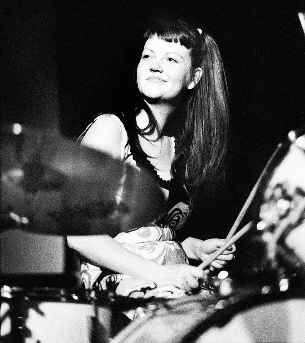 meg white smiles behind a drumset