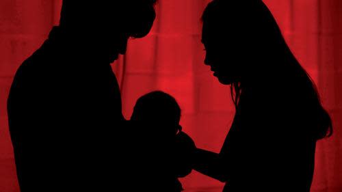 Couple and baby in silhouette