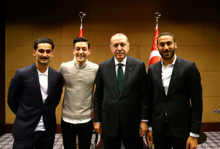 FILE PHOTO: Turkish President Tayyip Erdogan meets with Premier League soccer players Ilkay Gundogan of Manchester City, Mesut Ozil of Arsenal and Cenk Tosun of Everton in London, Britain May 13, 2018. Picture taken May 13, 2018. Kayhan Ozer/Presidential Palace/Handout via REUTERS/File Photo