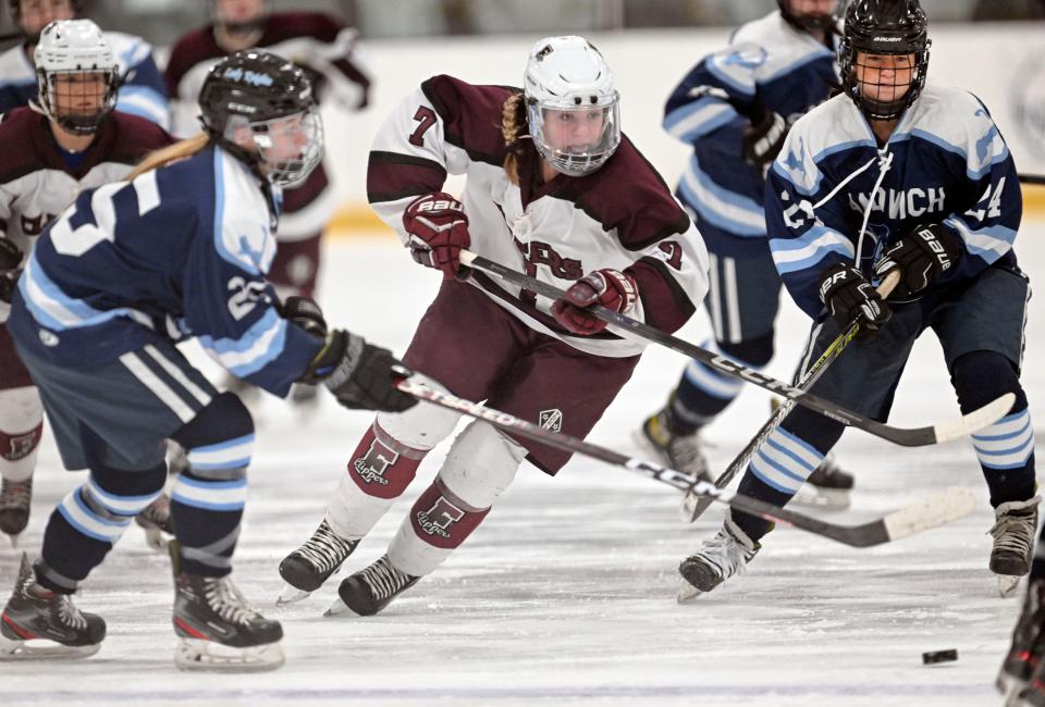 Maeve Turner of Falmouth races between Maddy Butler (25) and Khloe Schultz of Sandwich.