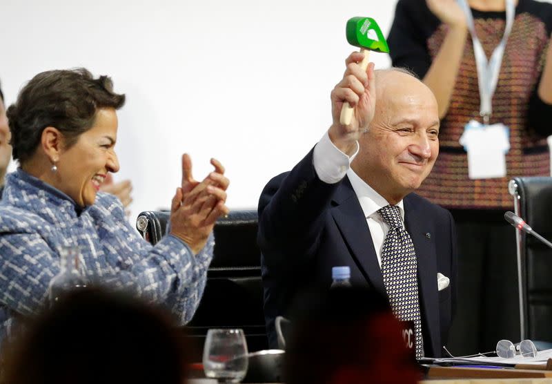 FILE PHOTO: French Foreign Affairs Minister Laurent Fabius, President-designate of COP21, and Christiana Figueres react at the World Climate Change Conference 2015 (COP21) at Le Bourget