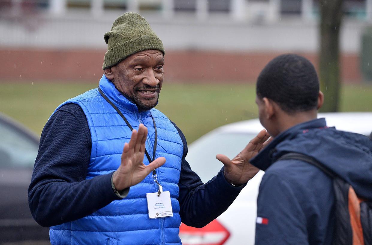 In this file photo from Feb. 7, 2019, Blue Coats coordinator Daryl Craig, then 62, at left, talks with Octavious Samples, then 17, at right, a senior at Erie High School.