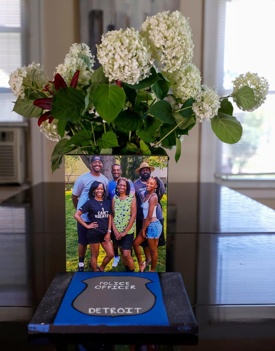 A family portrait sits on the dining room table at Larry and Lillian Courts' Detroit home on Thursday, July 7, 2022. Pictured left to right, front row to back are Leslie Courts, mother Lillian Courts, Lynette Courts, and brothers Larry, Loren and Lance Courts in a picture taken by their father and husband Larry Courts in 2019. Loren Courts, a five-year veteran of the Detroit Police Department, was shot and killed by a man with an assault rifle at Joy Road and Marlowe Street on Wednesday evening. Larry Courts, a 32-year veteran of the Detroit Police Department and father to Loren Courts said, u0022God needed him more than we did down here.u0022