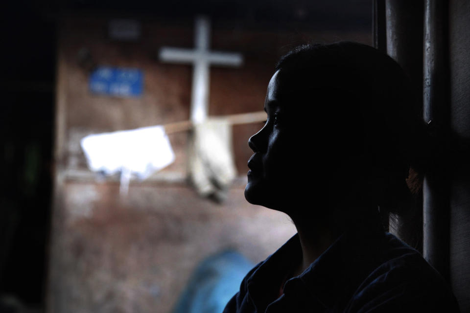 In this March 21, 2018, photo, Marip Lu sits in her family's shelter in a refugee camp in northern Kachin State, Myanmar. Marip Lu, 24, claims she was kidnapped by traffickers and suffered six years of captivity, rape and abuse deep in China. As the demand for "brides" in China rises, The Associated Press has pieced together the tragic ordeal of one woman who escaped, but had to leave her son behind. (AP Photo/Esther Htusan)