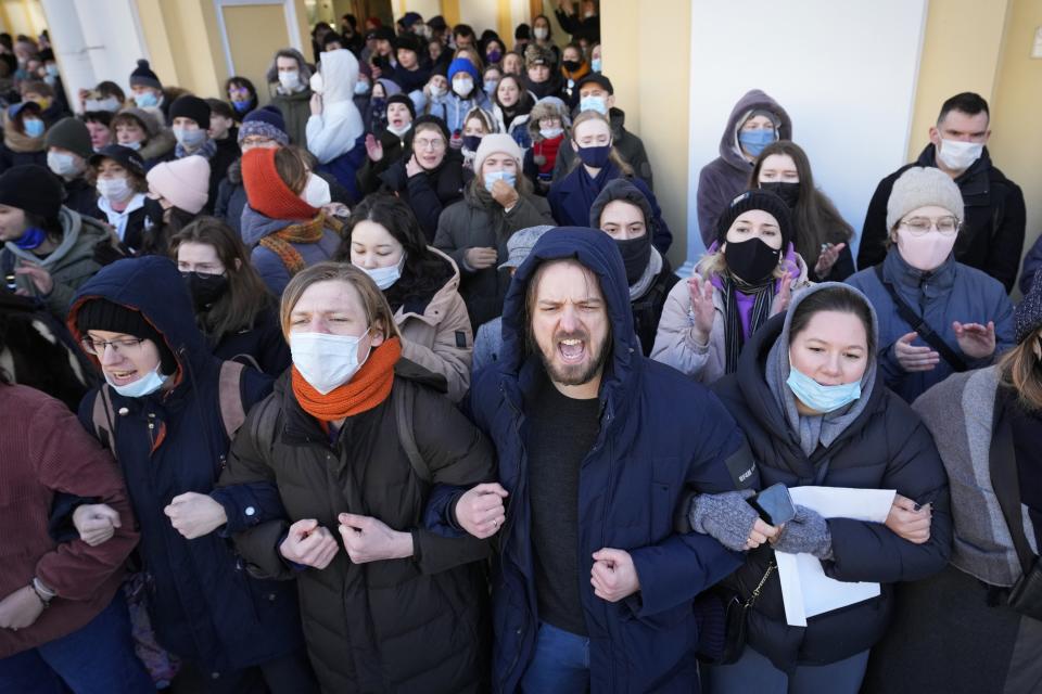 FILE - Demonstrators stand together, holding hands, at a demonstration in St. Petersburg, Russia, Sunday, Feb. 27, 2022. It's becoming increasingly difficult for Russians to escape government scrutiny. Activists say Putin’s government has managed to harness digital technology to surveil, censor and control Russians — new territory in a nation with a long history of spying on its citizens. (AP Photo, File)