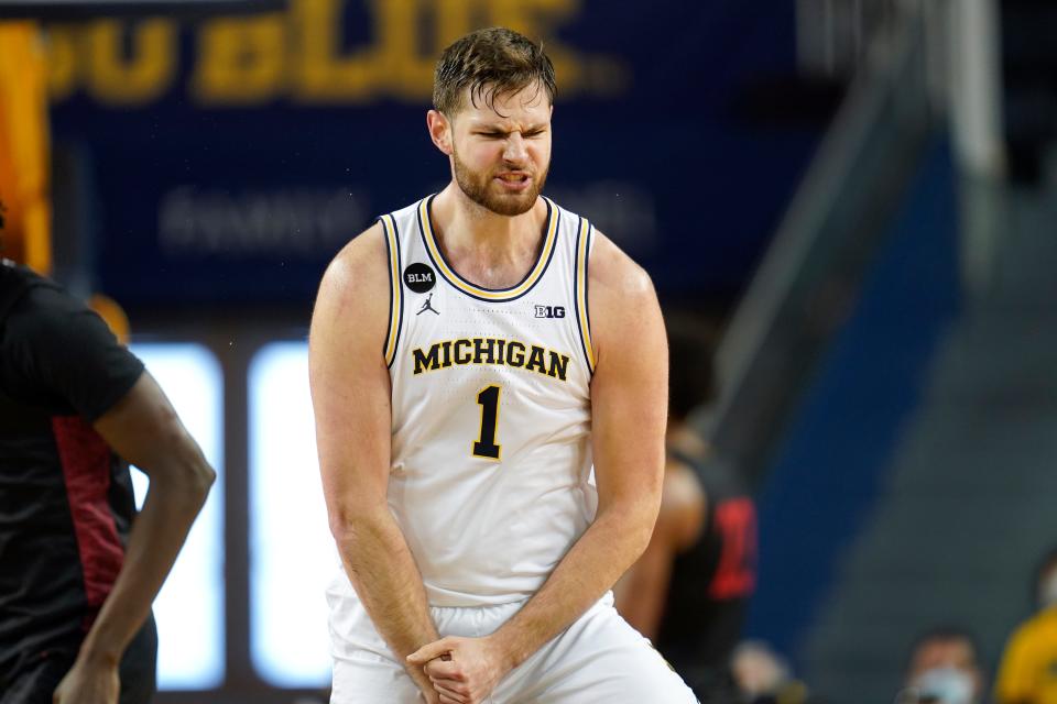 Michigan center Hunter Dickinson reacts to hitting 3-point basket against San Diego State in the first half in Ann Arbor on Saturday, Dec. 4, 2021.