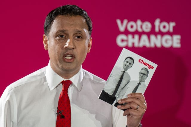 Anas Sarwar holding a copy of Scottish Labour's manifesto