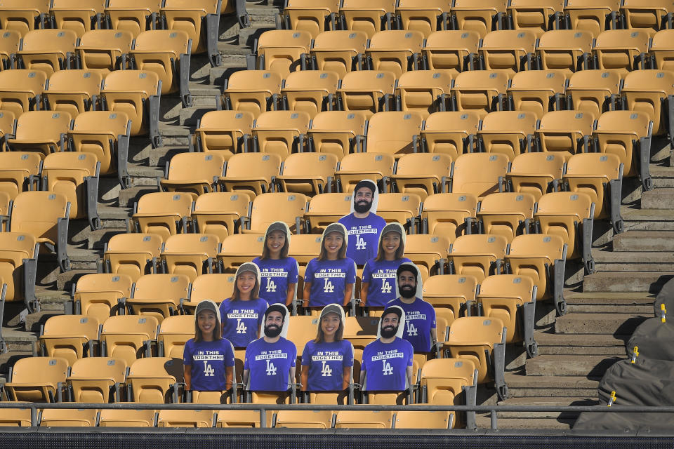 Examples of fan cutouts have been placed in the stands at Dodger Stadium prior a Los Angeles Dodgers intrasquad baseball game Wednesday, July 15, 2020, in Los Angeles. Fans are being invited to pay as much as $299 to have their pictures displayed in the seats during games, with net proceeds going to the Los Angeles Dodgers Foundation. (AP Photo/Mark J. Terrill)