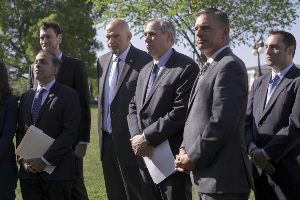 Sen. John Fetterman, D-Pa., center left, stands with Sen. Jeff Merkley, D-Ore., center right, Sen. Martin Heinrich, D-N.M., and other Democrats during a news conference on the "Ending Trading and Holdings in Congressional Stocks (ETHICS) Act" and efforts to ban members of Congress from trading stocks, at the Capitol in Washington, Tuesday, April 18, 2023. This is Fetterman's first week back after being treated for clinical depression for six weeks. (AP Photo/J. Scott Applewhite)