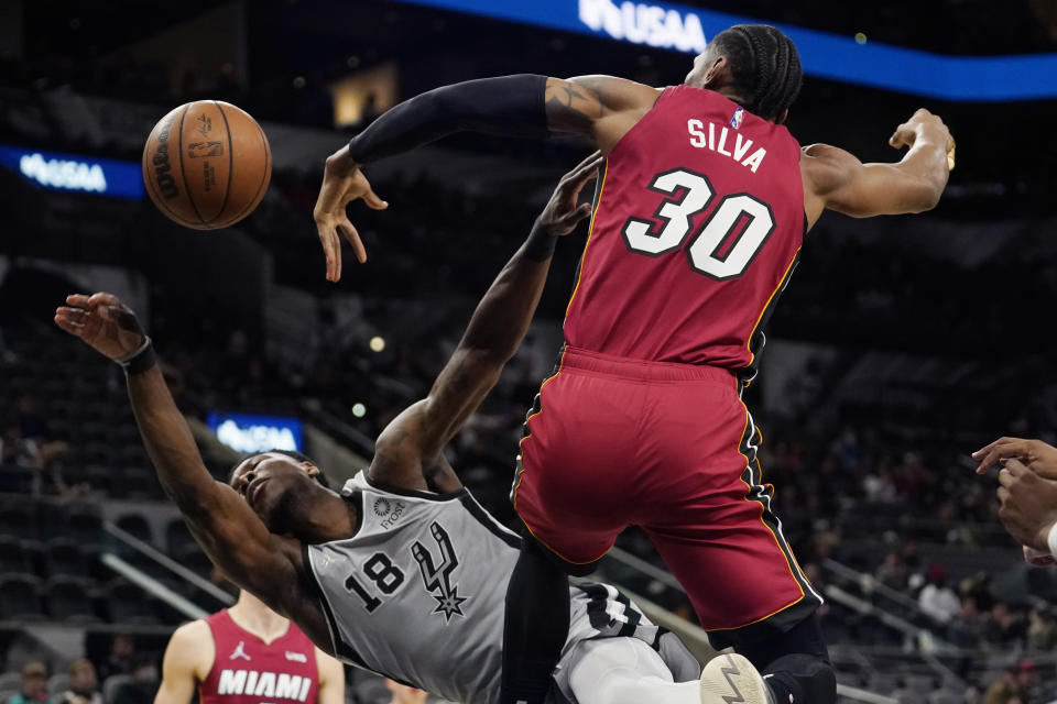San Antonio Spurs forward Devontae Cacok (18) is blocked by Miami Heat forward Chris Silva (30) as he tries to score during the second half of an NBA basketball game, Thursday, Feb. 3, 2022, in San Antonio. (AP Photo/Eric Gay)