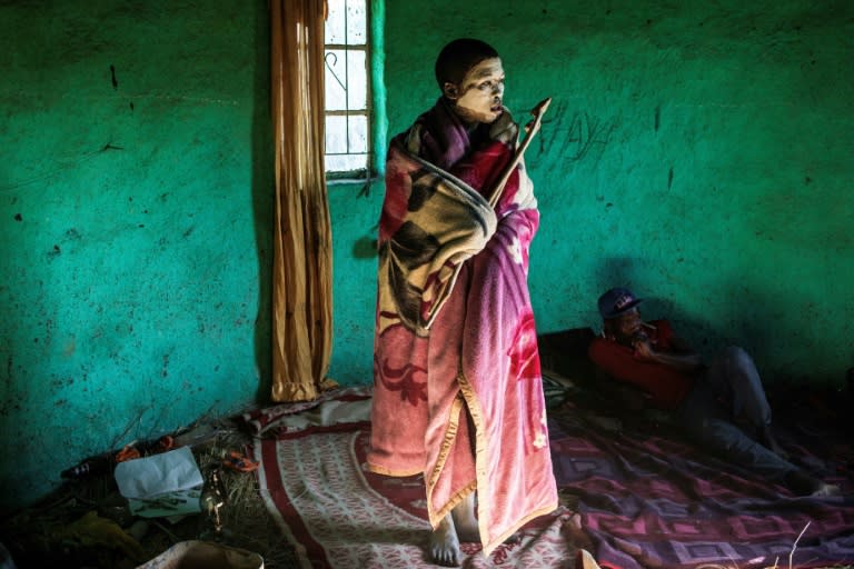 This file photo taken on July 11 shows traditional Xhosa initiate Fezikhaya Tselane, 20 years old, standing during a traditional initiation process in a rural hut in the Coffee Bay area in Umtata, South Africa