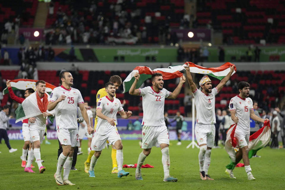 Tajikistan players celebrate their win during the Asian Cup round of 16 soccer match between Tajikistan and United Arab Emirates at Ahmad Bin Ali Stadium in Doha, Qatar, Sunday, Jan. 28, 2024. (AP Photo/Aijaz Rahi)