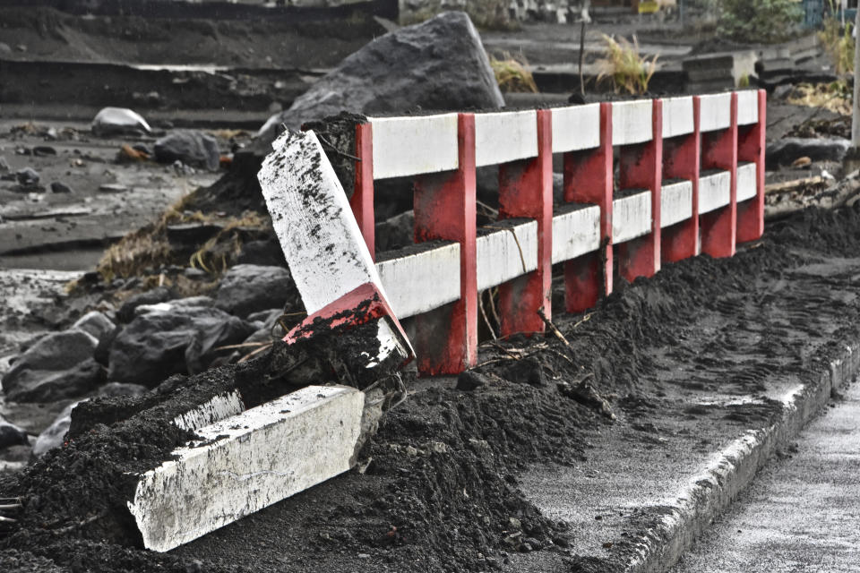 A damaged bridge stands after heavy rains poured down causing flooding and mudslides that damaged some homes and further battered areas already burdened by heavy ashfall from eruptions of La Soufriere volcano, in Kingstown, on the Caribbean island of St. Vincent, Thursday, April 29, 2021. (AP Photo/Orvil Samuel)