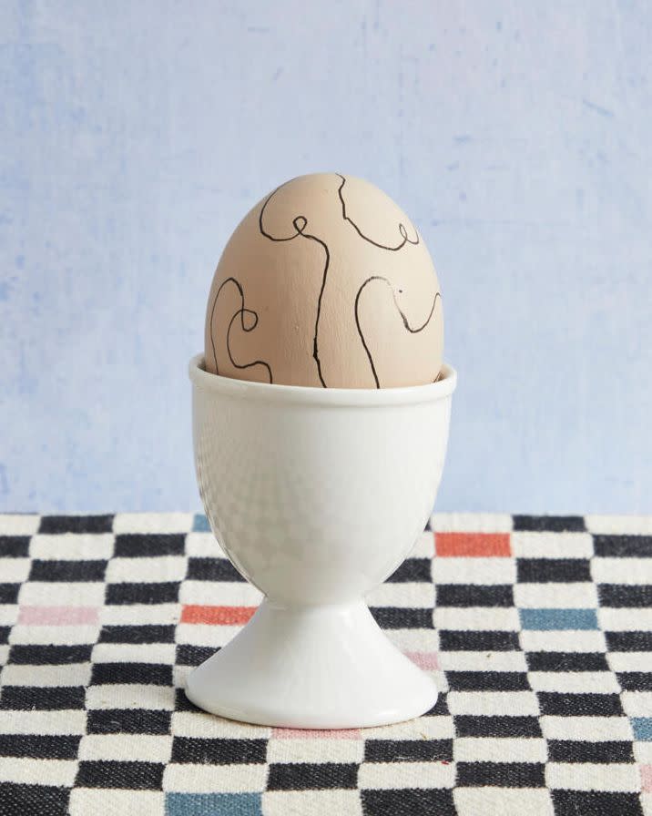 an easter egg decorated with black hand drawn lines for taylor swift's the tortured poets department album