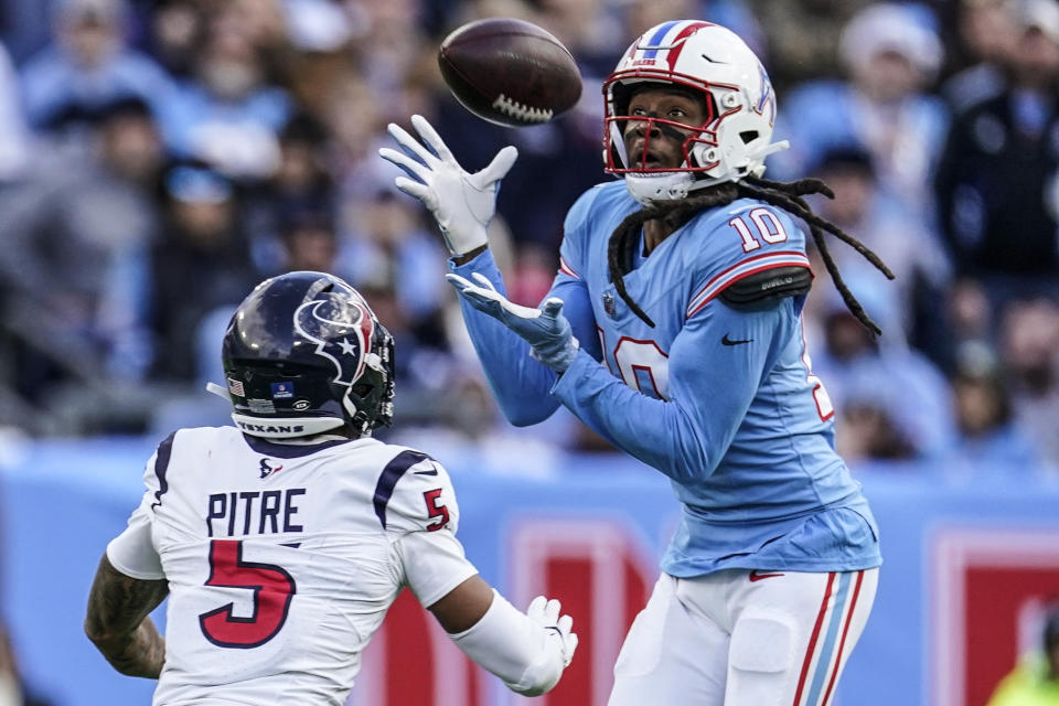 Tennessee Titans wide receiver DeAndre Hopkins (10) makes the catch against Houston Texans safety Jalen Pitre (5) during the second half of an NFL football game, Sunday, Dec. 17, 2023, in Nashville, Tenn. Hopkins, lost control of the ball for an incomplete pass. (AP Photo/George Walker IV)