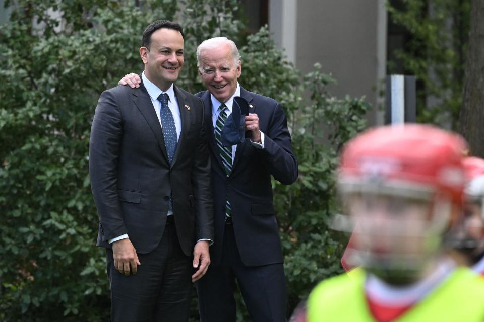 Ireland's Prime minister Leo Varadkar and President Joe Biden chat as they watch schoolchildren playing Gaelic sports in the field behind Farmleigh House, in Dublin, on April 13, 2023.