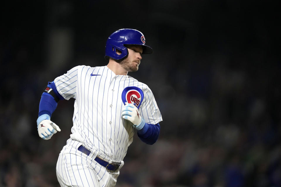 Chicago Cubs' Ian Happ watches his two-run single off Pittsburgh Pirates relief pitcher Yohan Ramirez during the sixth inning of a baseball game Wednesday, June 14, 2023, in Chicago. (AP Photo/Charles Rex Arbogast)