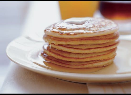 SERVINGS: MAKES ABOUT 28    <strong>INGREDIENTS  </strong>2 1/4 cups all purpose flour  2 teaspoons baking powder  1 teaspoon salt  2 cups whole milk  4 large eggs, separated  2 tablespoons (1/4 stick) or more unsalted butter, melted     2 tablespoons sugar     Additional melted butter  Pure maple syrup    <strong>PREPARATION  </strong>Whisk flour, baking powder, and salt in large bowl to blend. Whisk milk and egg yolks in medium bowl to blend. Whisk milk mixture into dry ingredients. Add 2 tablespoons melted butter and whisk until batter is smooth. Beat egg whites in another medium bowl until soft peaks form. Gradually add sugar, beating until stiff but not dry. Fold whites into batter in 2 additions. Heat nonstick griddle or large nonstick skillet over medium heat. Brush generously with additional melted butter. For each pancake, fill 1/4 cup measuring cup half full and drop batter onto griddle. Cook pancakes until bottoms are brown, about 3 minutes. Using spatula, turn pancakes over and cook until bottoms are brown and pancakes are cooked through, about 2 minutes. Transfer to plates. Serve warm with syrup.  <strong>  Photo by Tina Rupp</strong>