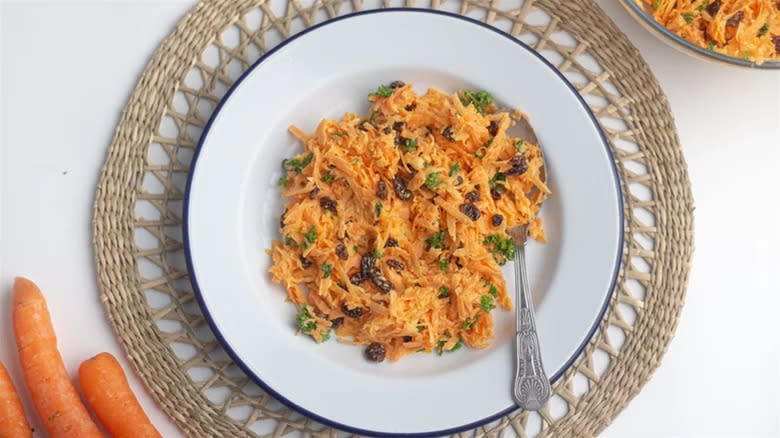 Carrot raisin salad on white plate