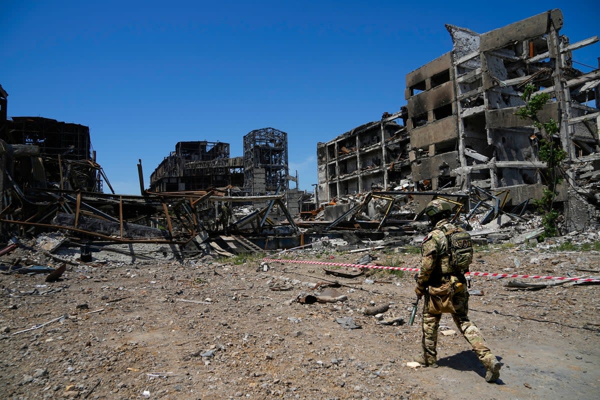 A Russian soldier walking past the devastated Mariupol steel plant  (AP)