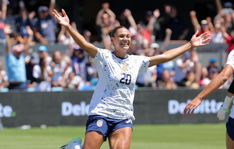 Rodman celebrates a goal during a friendly against Wales