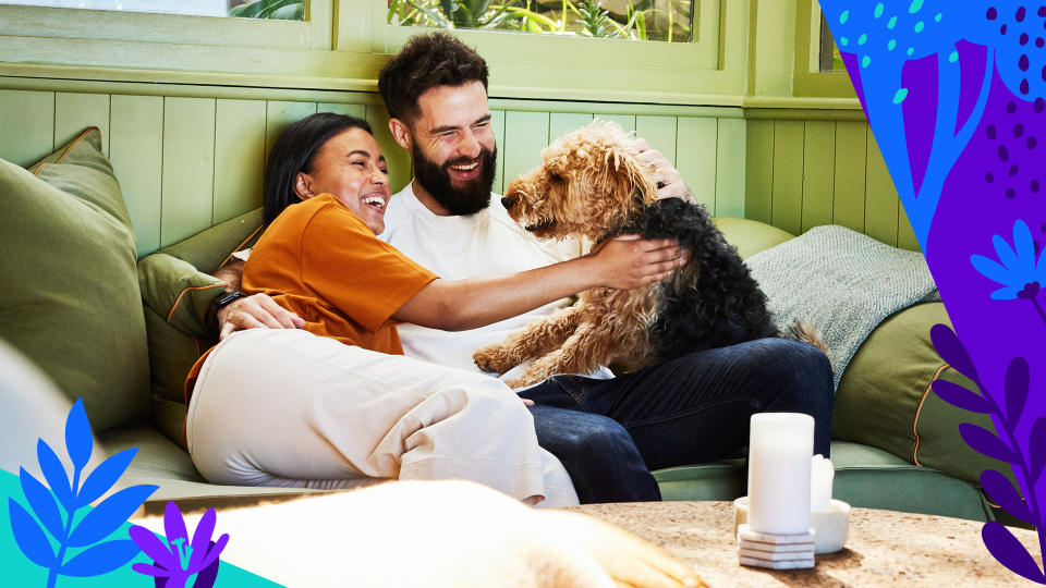 A couple enjoys the company of their Airedale.