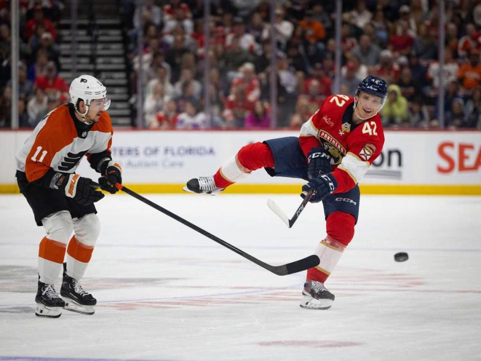 Florida Panthers defenseman Gustav Forsling (42) shoots the puck down the ice past Philadelphia Flyers right wing Travis Konecny (11) during the second period of a hockey game on Tuesday, Feb. 6, 2024, at Amerant Bank Arena in Sunrise, Fla.