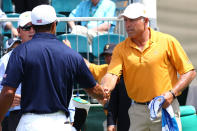 MELBOURNE, AUSTRALIA - NOVEMBER 17: (L-R) Tiger Woods of the U.S. Team and Steve Williams, caddie to Adam Scott (not pictured), shake hands on the first tee during the Day One Foursome Matches of the 2011 Presidents Cup at Royal Melbourne Golf Course on November 17, 2011 in Melbourne, Australia. (Photo by Ryan Pierse/Getty Images)