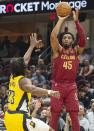 Cleveland Cavaliers' Donovan Mitchell (45) shoots over Indiana Pacers' Aaron Nesmith (23) during the first half of an NBA basketball game in Cleveland, Friday, April 12, 2024. (AP Photo/Phil Long)