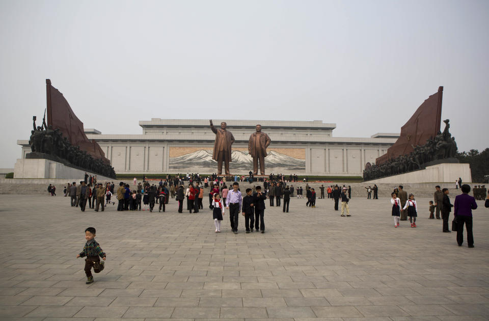 North Koreans arrive at Pyongyang's Mansu Hill to pay their respects to bronze statues of the late leaders Kim Il Sung and Kim Jong Il at Munsu Hill in Pyongyang on Tuesday, April 15, 2014, the official birthday of Kim Il Sung. (AP Photo/David Guttenfelder)