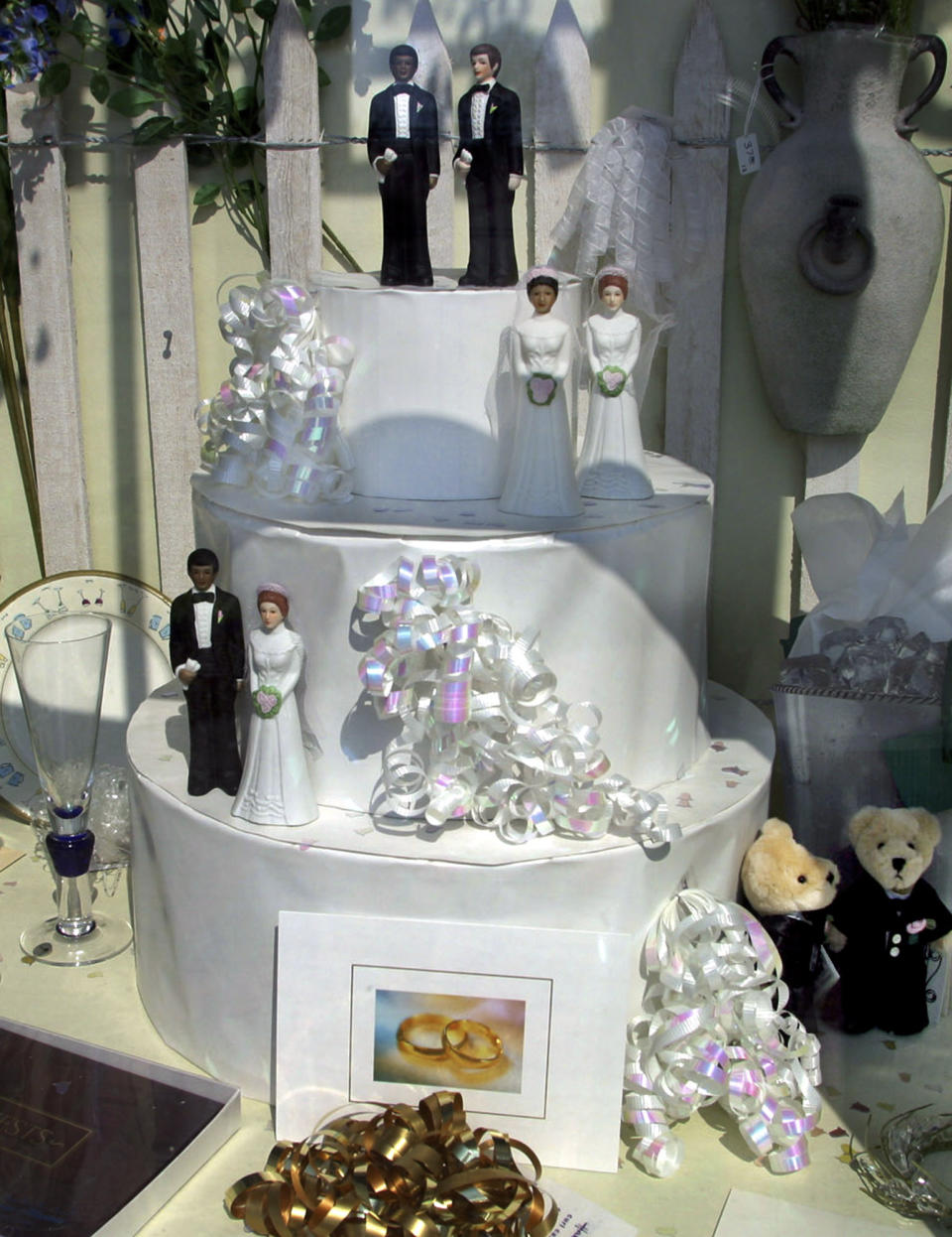 FILE - A window display at a wedding shop, in Provincetown, Mass., Saturday, May 15, 2004, features figurines of the same sex paired together on a wedding cake on the weekend before gay marriage becomes legal in Massachusetts. Provincetown, long considered a destination for gay and lesbian couples to vacation and relax, is expected to soon become a location where they may marry as well. (AP Photo/Julia Cumes, File)