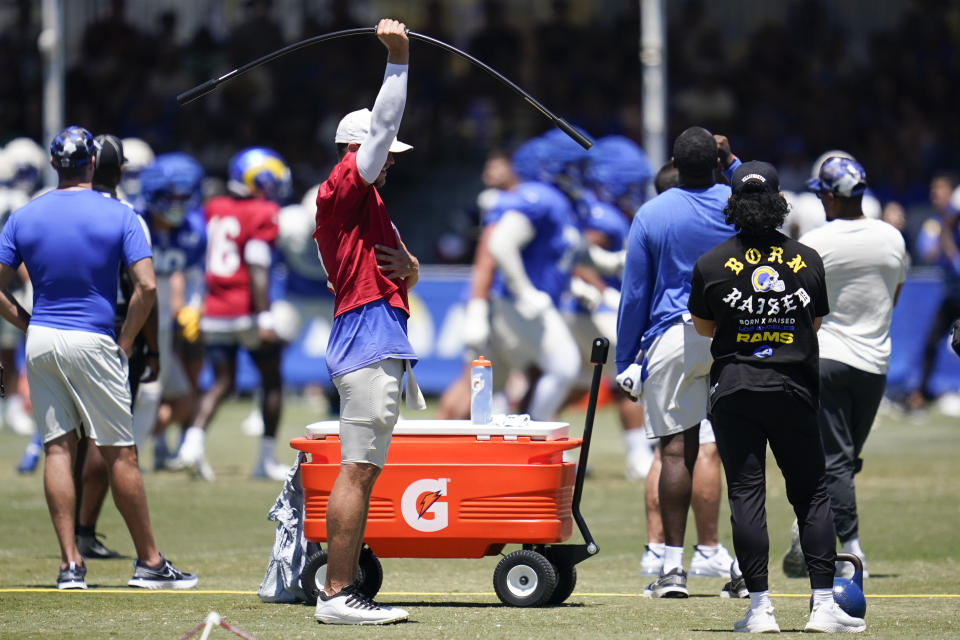 Los Angeles Rams quarterback Matthew Stafford, center, works with his right arm during NFL football training camp in Irvine, Calif., Saturday, Aug. 6, 2022. (AP Photo/Ashley Landis)