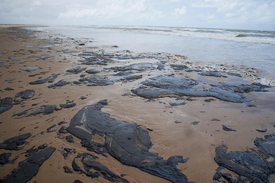 In this Sept. 25, 2019 photo released by the Sergipe state Government, spilt oil lays on the beach on Sergipe state, Brazil. Oil sludge started landing on Brazil's northeastern coast at the beginning of Sept., authorities say, and have now reached 61 municipalities in nine states, contaminating over 130 beaches. (Sergipe State Government vi aAP)
